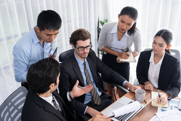 Diverse of business people from various ethnic group working in modern office environment. Productive and multi ethnic office workers engage in discussion for strategic business marketing. Meticulous