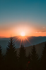 Obraz premium Serene Sunrise over Mountain Landscape with Pine Trees Silhouetted Against a Radiant Backdrop