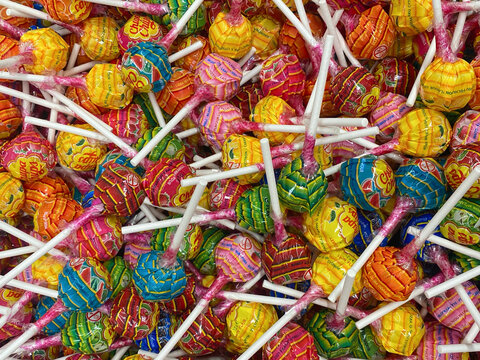 Poznan, Poland - 08.03.2024: Brightly colored candy on a stick chupa chups close-up. Background of colorful candy chupa chups. Texture of chupa chups candies