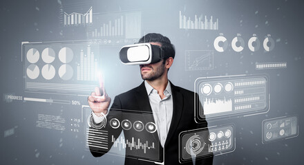 Skilled business man looking data analysis while planning strategy by using visual reality glasses. Professional smart investor checking financial graph holographic while wearing VR goggle. Deviation.