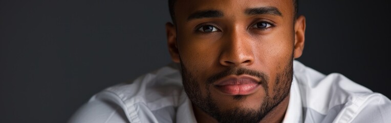 Obraz premium Confident Man Posing Against a Dark Solid Background