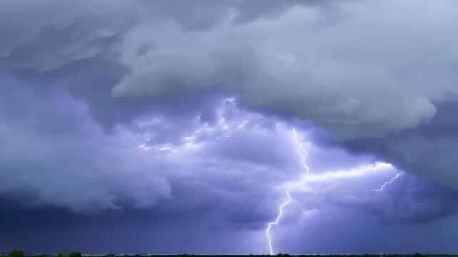 The crackling energy of a thunderstorm as bolts of lightning strike down and illuminate the brooding storm clouds.