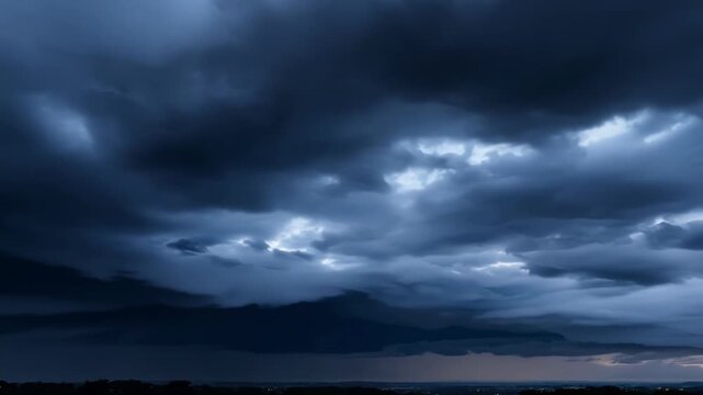 The sky is painted in shades of black grey and indigo as the clouds continue to darken.