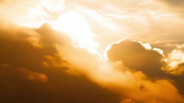The clouds appearing to be aglow with a golden aura as the sunlight reflects off their tops.
