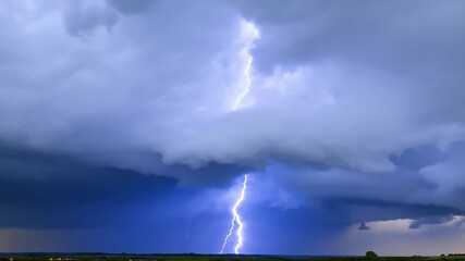 An ominous storm brewing within a cloud bank with flashes of lightning illuminating the dark underbelly.