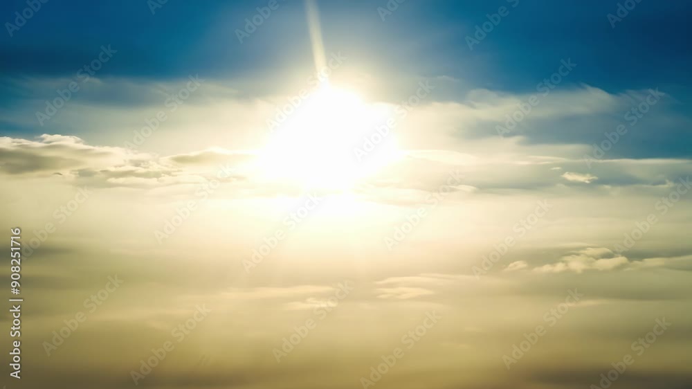 Poster Beneath a thin cloud veil the sun casts dazzling rays of light creating a breathtaking display.