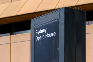 Black metallic monolith with the name of Sydney Opera House on Sydney Harbour, New South Wales, Australia