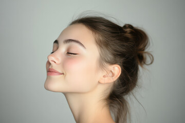 Fototapeta premium A close up of a girl's face with her eyes closed