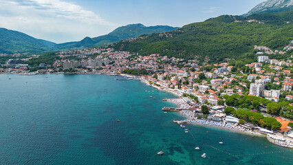Fototapeta premium Aerial view of a waterfront residential area in Igalo on the coast of the Adriatic Sea in the Bay of Kotor in Montenegro