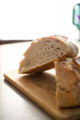 Close-up of a slice of bread on a cutting board, backlit.