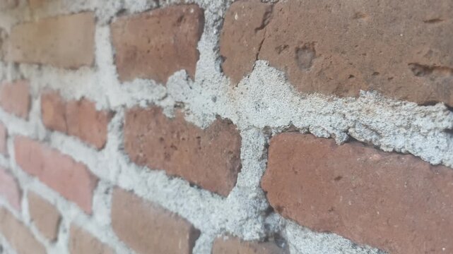 4K footage with View of the old Red Brick Wall. Close up shot slow motion. Close up tilt shot of an old red brick wall