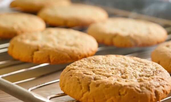Freshly Baked Goodness: Golden-brown cookies cooling on a rack, their irresistible aroma filling the air. 