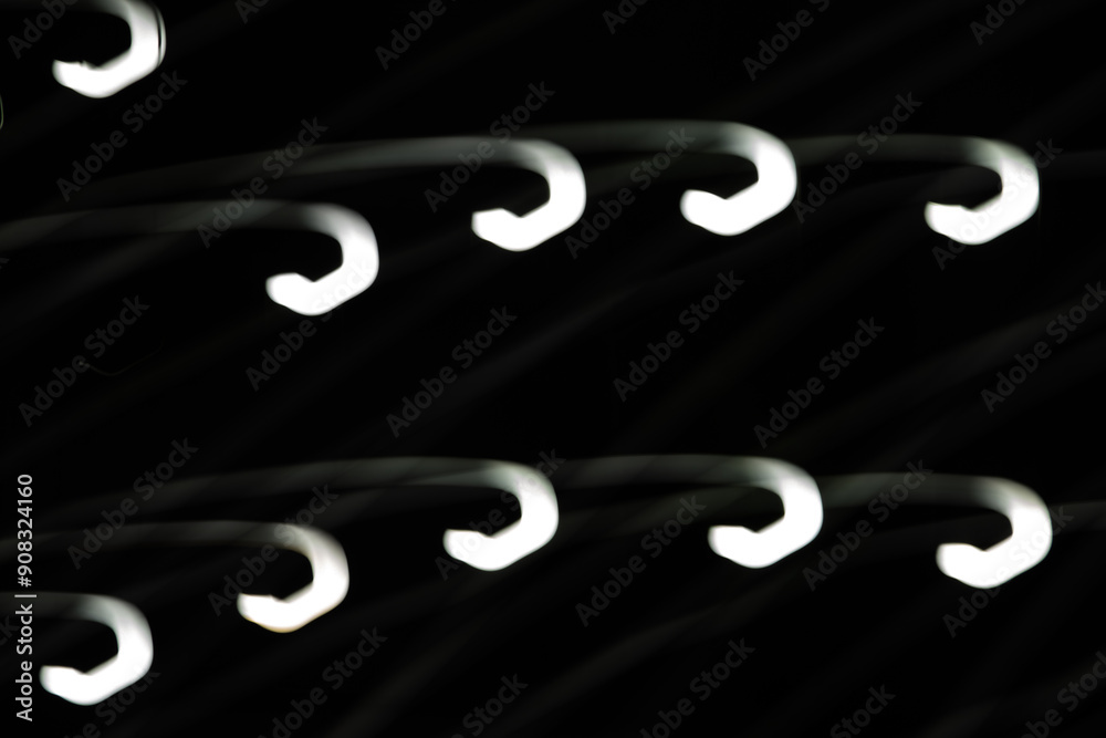 Wall mural the image is a series of white lines that are curved and overlapping. the lines are black and white,