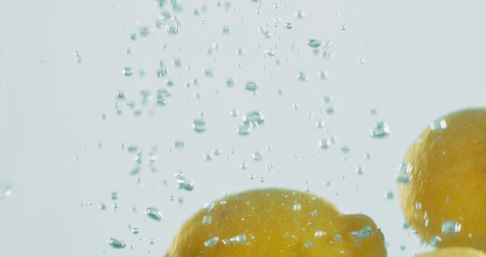 Fruit, lemon and vitamin c with water splash for natural nutrition, fresh produce or hydration in studio on a white background. Closeup of juicy, citric acid or wet organic food for healthy diet