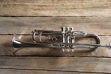 Trumpet on wooden table, top view. Wind musical instrument