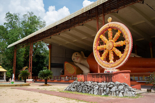 Giant sleeping Buddha under roof with Dhamma wheel at Wat Phothivihan