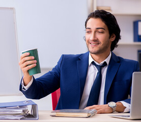 Young handsome businessman working in the office