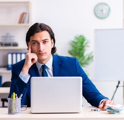 Young businessman sitting and working in the office