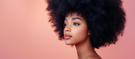 Fototapeta premium African American woman with nude glossy lips and afro hairstyle posing with peach background, showcasing beauty and fashion trends