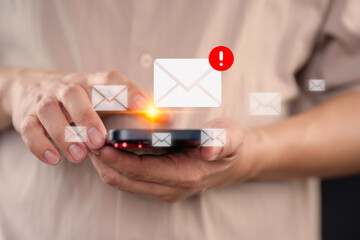 Young man using a smartphone receives a new email notification, highlighting the email and internet communication, data, digital marketing, e-mail icon technology and online networking concept.