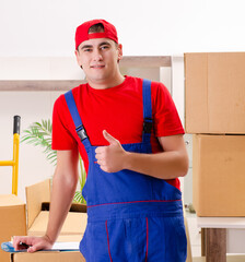 Young contractor with boxes working indoors