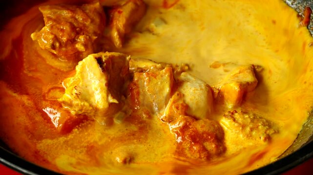 Cooking chicken tikka masala in pan, in door Chiangmai Thailand.