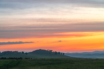 Landscape of grassland and mountain under twilight