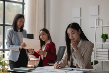 three businessperson are working in the modern office, group of employee has discussion about new project, working as teamwork is more effective, coworkers are brainstorming to planing great strategy