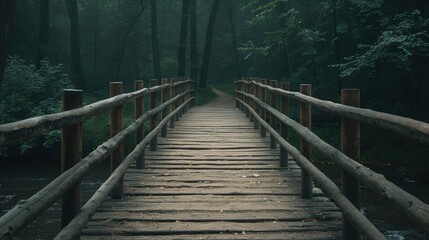Obraz premium A serene wooden bridge leading through a foggy forest, inviting exploration and adventure in nature's tranquility.