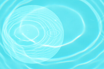 Blue water with ripples on the surface. Defocus blurred transparent blue colored clear calm water surface texture with splashes and bubbles. Water waves with shining pattern texture background.