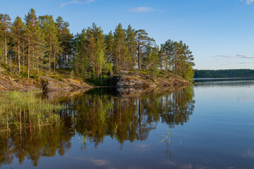 The shore of Koyonsaari island on a warm June evening. Karelia, Russia