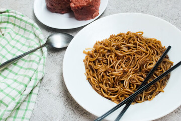 dry ramen noodle dish with chopsticks