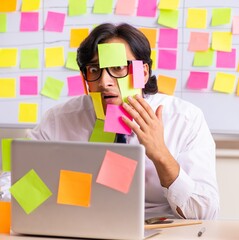 Young employee in conflicting priorities concept