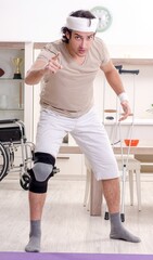 Injured young man doing exercises at home