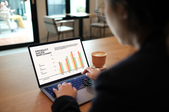 young woman sitting on sofa using laptop at cafe surfing, doing online ecommerce shopping, looking at computer ordering sale products on website, watching videos or elearning