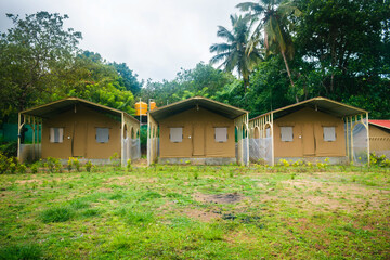 A picturesque campsite with multiple tent accommodations, surrounded by dense forest.