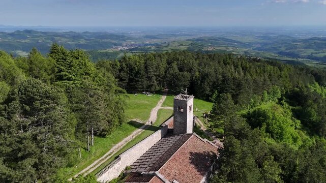 San Mauro di Saline, Italy - 05 05 2024:  Ancient hermitage of San Moro. Aerial shot of the beautiful church on Mount Moro. Romanesque-Gothic construction, monastic community. Lessinia plateau.