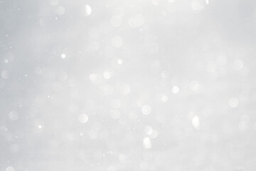 Blurred white bokeh background, snow sparkles in the sun