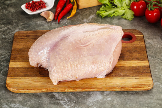 Raw chicken breast with skin