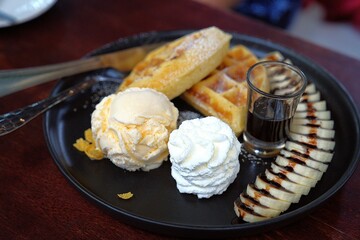 Delicious ice cream and waffles in a cozy cafe