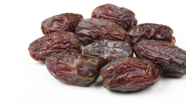 plusieurs dattes medjoul, en gros plan, isol&eacute;es sur un fond blanc