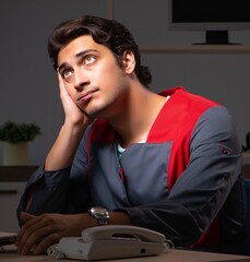 Young handsome repairman repairing computer