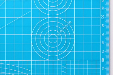 blue cutting mat board on white background with line and scale measure guide pattern for object art design, tool equipment of diy craft work