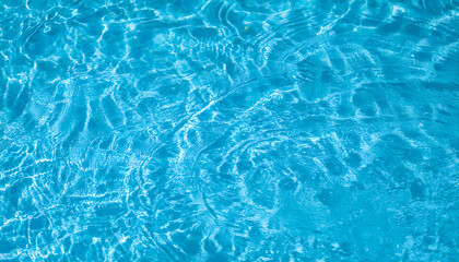 Fototapeta premium Blue water background. Close-up of the blue waters of the swimming pool from above.