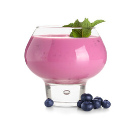 Glass of fresh blueberry smoothie with mint and berries on white background