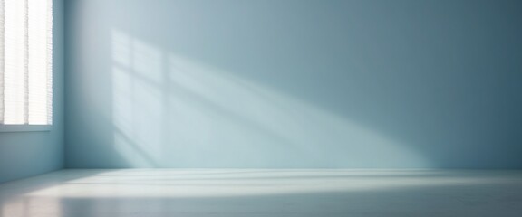 Obraz premium Minimalistic abstract gentle light blue background for product presentation with light and intricate shadow from window on wall.