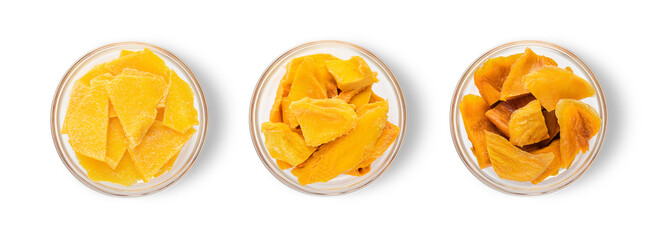 Glass bowl with various dried mango slices on white background.Top view.Macro.