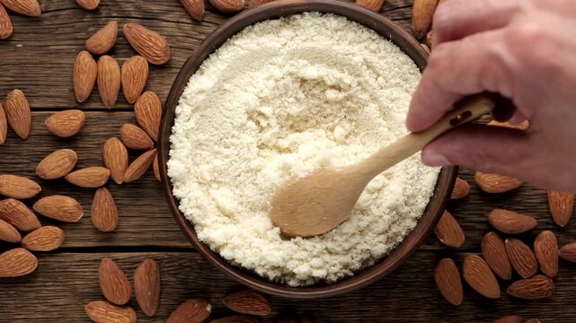 Fresh almond flour in a bowl and almonds. Gluten free food concept.