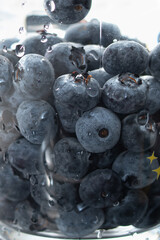 American blueberries in a transparent glass with water. Washing berries. Healthy eating. Vitamins.