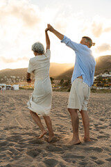 Beautiful happy senior couple dating at the seaside during summertime - Mature married couple in...